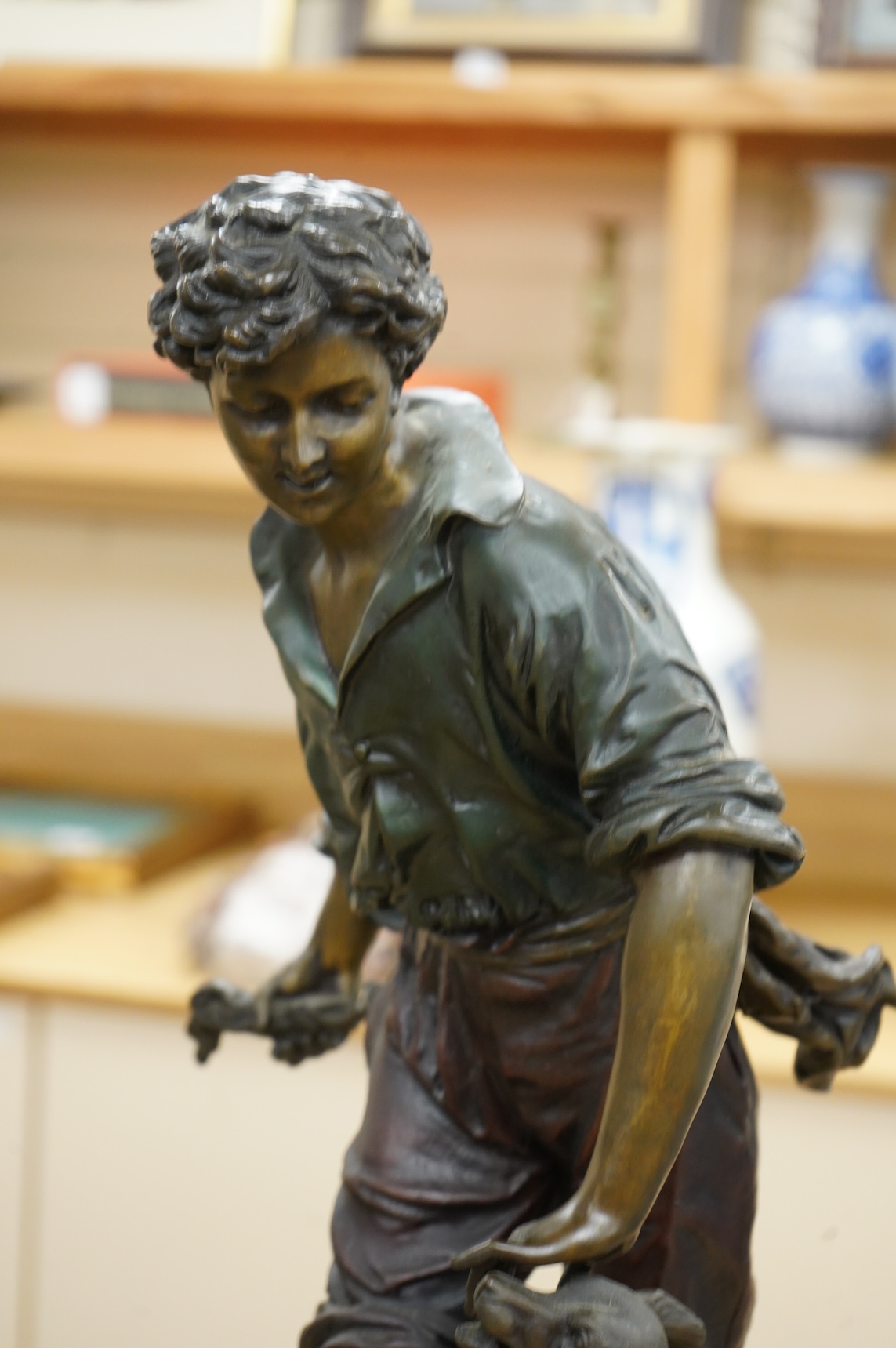A large painted spelter model of a boy with a dog, on stand - 68cm high